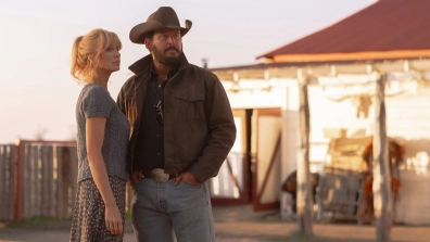 Kelly Reilly as Beth Dutton and Cole Hauser as Rip Wheeler stand outside a ranch at sunset in Dutton Ranch season 1, episode 8 on Paramount+